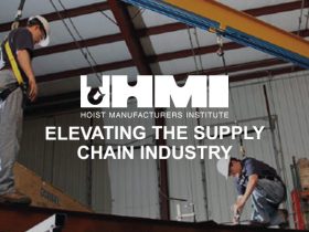 Hoist safety. two men attached in safety harnesses on hoist equipment