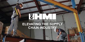 Hoist safety. two men attached in safety harnesses on hoist equipment